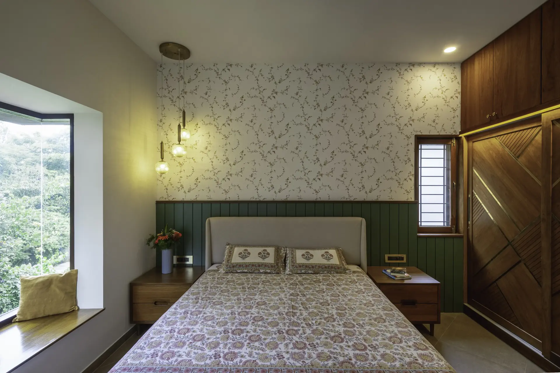 Daughter's bedroom with green panel and floral print wallpaper